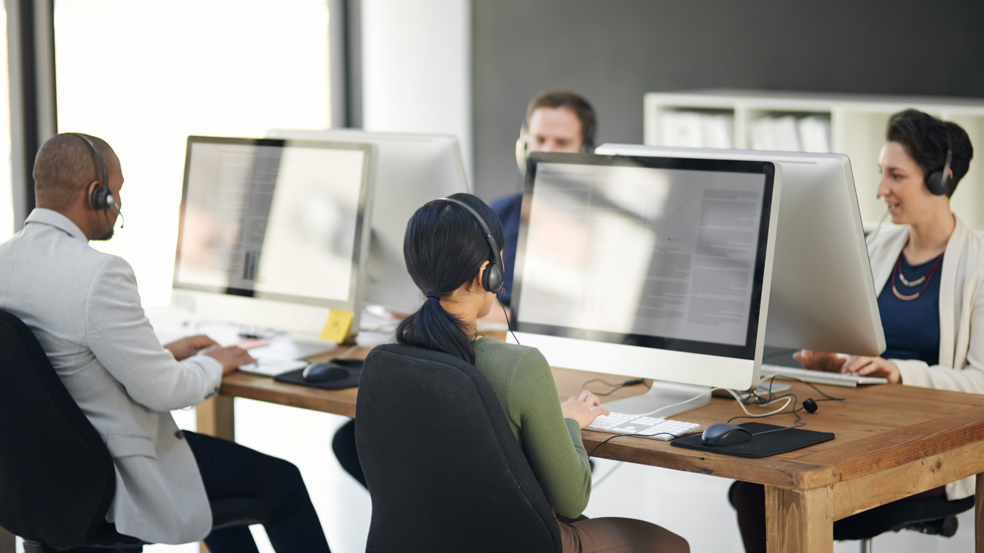 Several people working at a help desk.